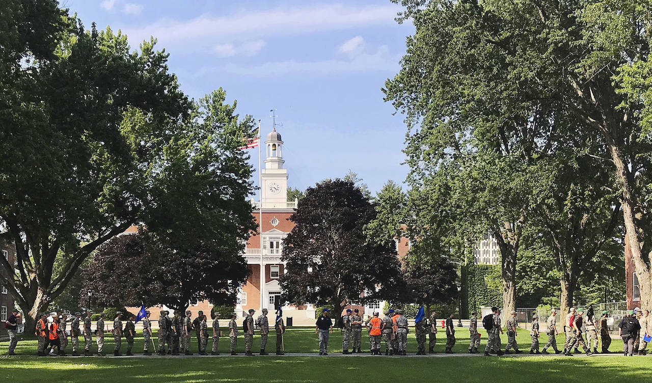 FILE - In this Monday, July 16, 2018 photo, a group in military fatigues walks in front of Jackman ...