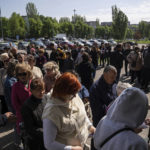 
              People stand in line for registration at the aid distribution center for displaced people in Zaporizhia, Ukraine, Thursday, May 5, 2022. (AP Photo/Evgeniy Maloletka)
            