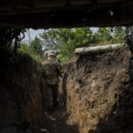 
              A member of the Ukrainian Territorial Defense Force walks through a trench in the Kharkiv area of ​​eastern Ukraine, Monday, May 30, 2022. (AP Photo/Bernat Armangue)
            