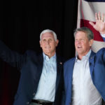 
              Former Vice President Mike Pence, left, and Georgia Gov. Brian Kemp greet the crowd during a rally, Monday, May 23, 2022, in Kennesaw, Ga. Pence is opposing former President Donald Trump and his preferred Republican candidate for Georgia governor, former U.S. Sen. David Perdue. (AP Photo/Brynn Anderson)
            