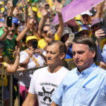 
              Brazil's President Jair Bolsonaro waves to supporters as he arrives at the Labor Day and Freedom rally, in Brasilia, Brazil, Sunday, May 1, 2022. (AP Photo/Eraldo Peres)
            