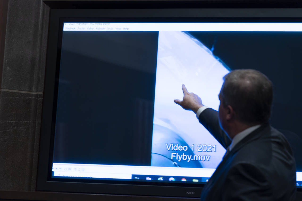 Deputy Director of Naval Intelligence Scott Bray points to a video display of a UAP during a hearin...