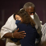 
              New York Gov. Kathy Hochul hugs Charles Everhart Sr. as service ends at True Bethel Baptist Church on Sunday, May 15, 2022, in Buffalo, N.Y.. Everhart's grandson, Zaire Goodman, was shot in the neck and survived during a shooting at a Buffalo supermarket on May 14. Goodman was released from the hospital last night. "I'm just grateful that God saved his life," said Everhart. (AP Photo/Joshua Bessex)
            