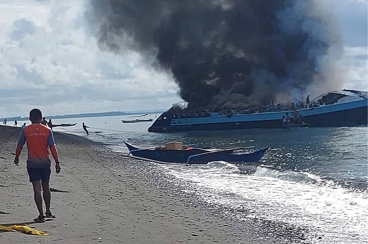 In this handout provided by the Philippine Coast Guard, smoke billows from ferry M/V Mercraft 2 as ...