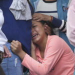 
              A woman cries outside the morgue where families wait for the bodies of dead inmates to be released after a deadly riot broke out in Bellavista jail in Santo Domingo de los Tsachilas, Ecuador, Tuesday, May 10, 2022. (AP Photo/Dolores Ochoa)
            