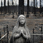 
              Blackened tombstones and statues stand at the Rociada Cemetery after fire tore through the area in the evacuation area near Mora, N.M., on Wednesday, May 4, 2022, where firefighters have been battling the Hermit's Peak and Calf Canyon fire for weeks. Many residents have resisted the evacuation orders opting to stay and protect their homes to face nature's fury. Weather conditions described as potentially historic are on tap for New Mexico on Saturday, May 7 and over the next several days as the largest fire burning in the U.S. chews through more tinder-dry mountainsides. (Jim Weber/Santa Fe New Mexican via AP)
            