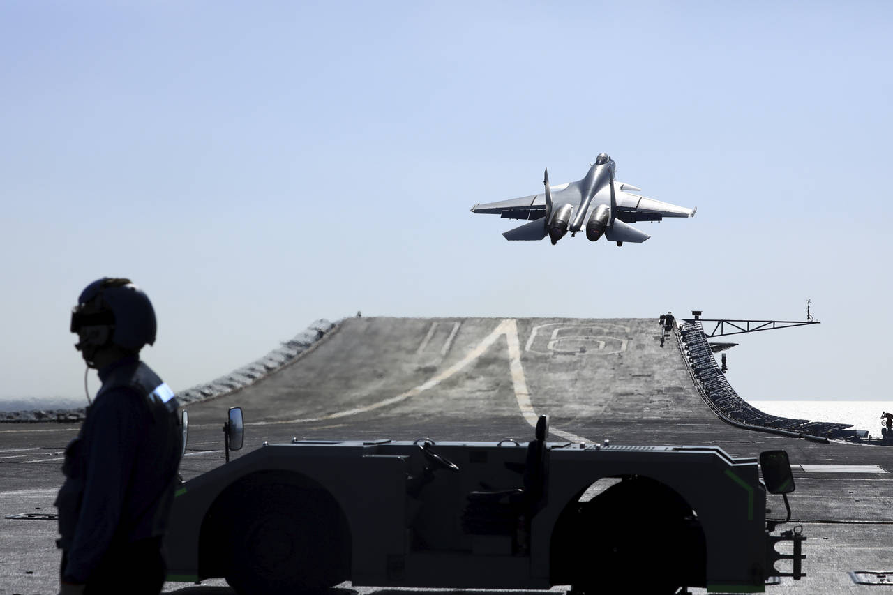 In this undated photo released on Dec. 31. 2021, by Xinhua News Agency, a carrier-based J-15 fighte...