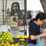 
              A woman walks past a fruit vendor at a street market in Rio de Janeiro, Brazil, Wednesday, May 11, 2022. High inflation in Brazil is eroding the buying power of consumers and angering potential voters, who fault President Jair Bolsonaro for not doing enough about it. (AP Photo/Silvia Izquierdo)
            