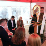 
              First lady Jill Biden sits with Slovakia's Prime Minister Eduard Hege as Capt. Frantisek Krusinsky, Priest from the Ordinariate of Slovak Armed Forces, leads a prayer in Vysne Nemecke, Slovakia, near the border with Ukraine, Sunday, May 8, 2022. (AP Photo/Susan Walsh, Pool)
            