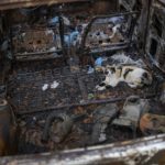 
              A cat rests inside an abandoned, burned-out car in the El Paraiso neighborhood of Caracas, Venezuela, Tuesday, April 19, 2022. While used cars are banned for import in Venezuela, old cars make up the majority of the capital's vehicular fleet and are expensive to maintain. (AP Photo/Matias Delacroix)
            