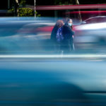 
              Pedestrians waits to cross Roosevelt Boulevard in Philadelphia, Monday, May 9, 2022. Roosevelt Boulevard is an almost 14-mile maze of chaotic traffic patterns that passes through some of the city's most diverse neighborhoods and Census tracts with the highest poverty rates. Driving can be dangerous with cars traversing between inner and outer lanes, but biking or walking on the boulevard can be even worse with some pedestrian crossings longer than a football field and taking four light cycles to cross. (AP Photo/Matt Rourke)
            