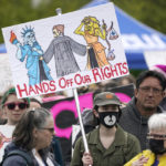 
              A person holds a sign that reads "Hands Off Our Rights" during a protest and rally for abortion rights, Saturday, May 14, 2022, in Seattle. Demonstrators are rallying from coast to coast in the face of an anticipated Supreme Court decision that could overturn women’s right to an abortion.  (AP Photo/Ted S. Warren)
            