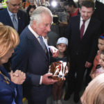 
              Britain's Prince Charles and Princess Margaret, the Custodian of the Romanian Crown, offer presents to refugees during a visit at a center for refugees fleeing the war in neighboring Ukraine, at the Romexpo convention center, in Bucharest, Romania, Wednesday, May 25, 2022. (Alex Micsik/Pool via AP)
            