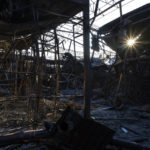 
              The sun's rays pass through charred structures of one of the shelled sections of the Barabashovo market in Kharkiv, eastern Ukraine, Monday, May 23, 2022. (AP Photo/Bernat Armangue)
            
