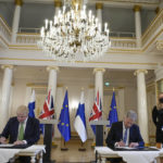 
              British Prime Minister Boris Johnson, left, and Finland's President Sauli Niinisto sign a security assurance, at the Presidential Palace in Helsinki, Finland, Wednesday, May 11, 2022. Britain has signed a security assurance with Sweden and its neighbor Finland, that are both pondering whether to join NATO following Russia's invasion of Ukraine, pledging to "bolster military ties" in the event of a crisis and support both countries should they come under attack. (AP Photo/Frank Augstein, Pool)
            