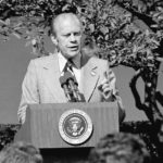 
              President Ford holds a White House Rose Garden news conference Oct. 9, 1974, the day after disclosing his anti-inflation program. The Chief Executive is wearing one of his WIN-Whip Inflation Now-buttons on his lapel. Stagflation. It was the dreaded "S word" of the 1970s. For Americans of a certain age, it conjures memories of painfully long lines at gas stations, shuttered shops and factories and President Gerald Ford's much-ridiculed "Whip Inflation Now" buttons. (AP Photo/File)
            