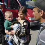 
              Ukrainian pregnant woman Alyona, 20, her husband Leonid, 30, right, and their son Sergei, 1 wait for boarding during an evacuation of civilians in Kramatorsk, Ukraine, Saturday, April 30, 2022. (AP Photo/Andriy Andriyenko)
            