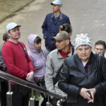 
              People wait in a queue to receive humanitarian aid in Kramatorsk, Ukraine, Friday, May 6, 2022. (AP Photo/Andriy Andriyenko)
            