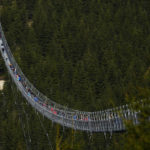 
              Visitors cross a suspension bridge for the pedestrians that is the longest such construction in the world shortly after its official opening at a mountain resort in Dolni Morava, Czech Republic, Friday, May 13, 2022. The 721-meter (2,365 feet) long bridge is built at the altitude of more than 1,100 meters above the sea level. It connects two ridges of the mountains up to 95 meters above a valley between them. (AP Photo/Petr David Josek)
            