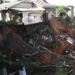 
              Damaged homes on the edge of a precipice caused by flooding waters near Durban, South Africa, Monday, May 23, 2022. More than 300 people have been evacuated from their homes as a result of renewed heavy rains, flooding and mudslides in South Africa's KwaZulu-Natal province, weeks after severe flooding killed more than 400 people and displaced more than 40,000 others. (AP Photo)
            