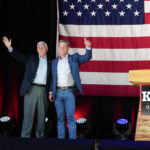 
              Former Vice President Mike Pence, left, and Georgia Gov. Brian Kemp greet the crowd during a rally, Monday, May 23, 2022, in Kennesaw, Ga. Pence is opposing former President Donald Trump and his preferred Republican candidate for Georgia governor, former U.S. Sen. David Perdue. (AP Photo/Brynn Anderson)
            