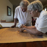 
              Jeanne Malmkar, 75, and her husband Collin, 79, examine a map of the original canal plan given to her by her grandfather Saturday, April 30, 2022, in Grant, Neb. Her great-grandfather worked on a failed 1898 effort to dig a canal from Ovid, Colo. (AP Photo/Brittany Peterson)
            