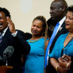 
              FILE - Garnell Whitfield Jr., left, the son of Ruth Whitfield, a victim of shooting at a supermarket, speaks with members of the media during a news conference in Buffalo, N.Y., Monday, May 16, 2022.  After a weekend of gun violence in America,  when shootings killed and wounded people grocery shopping, going to church and simply living their lives, the nation marked a milestone of 1 million deaths from COVID-19. The number, once unthinkable, is now a pedestrian reality in the United States, just as is the reality of the continuing epidemic of gun violence that kills tens of thousands of people a year. (AP Photo/Matt Rourke, File)
            