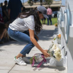
              Meghan Markle, Duchess of Sussex, leaves flowers at a memorial site, Thursday, May 26, 2022, for the victims killed in this week's elementary school shooting in Uvalde, Texas. (AP Photo/Jae C. Hong)
            