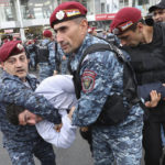 
              Police detain a demonstrator during a protest rally, in Yerevan, Armenia, Monday, May 2, 2022. Police in Armenia's capital on Monday detained 125 anti-government demonstrators that were blocking streets to protest against Prime Minister Nikol Pashinyan. (Vahram Baghdasaryan/Photolure via AP)
            