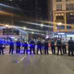 
              Chicago police block traffic near State and Monroe streets after crowds of young people flooded the Loop after a fatal shooting in Millennial Park in Chicago, late Saturday, May 14, 2022. (Tina Sfondeles/Chicago Sun-Times via AP)
            