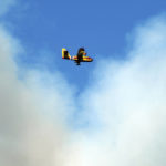 
              A firefighting plane flies in front of a plume of smoke near Las Vegas, N.M., on Tuesday, May 3, 2022. Flames raced across more of New Mexico's pine-covered mountainsides Tuesday, charring more than 217 square miles (562 square kilometers) over the last several weeks. (AP Photo/Thomas Peipert)
            