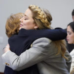 
              Actor Amber Heard hugs her attorney attorney Elaine Bredehoft in the courtroom at the Fairfax County Circuit Courthouse in Fairfax, Va., Friday, May 27, 2022. Actor Johnny Depp sued his ex-wife Amber Heard for libel in Fairfax County Circuit Court after she wrote an op-ed piece in The Washington Post in 2018 referring to herself as a "public figure representing domestic abuse." (AP Photo/Steve Helber, Pool)
            