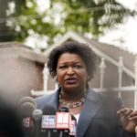 
              Georgia Democratic gubernatorial candidate Stacey Abrams talks to the media during Georgia's primary election on Tuesday, May 24, 2022, in Atlanta. (AP Photo/Brynn Anderson)
            