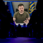
              Ukrainian President Volodymyr Zelenskyy displayed on a screen as he addresses the audience from Kyiv on a screen during the World Economic Forum in Davos, Switzerland, Monday, May 23, 2022. The annual meeting of the World Economic Forum is taking place in Davos from May 22 until May 26, 2022. (AP Photo/Markus Schreiber)
            