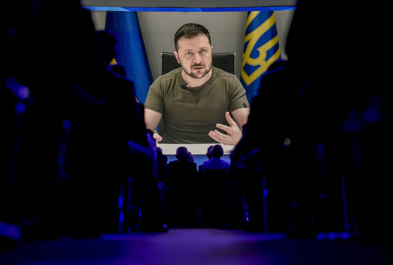 Ukrainian President Volodymyr Zelenskyy displayed on a screen as he addresses the audience from Kyi...