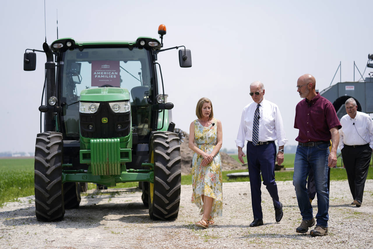 President Joe Biden walks with O'Connor Farms owners Jeff O'Connor and Gina O'Connor, left, at the ...