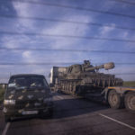 
              A truck transports a platform with a Ukrainian self-propelled artillery vehicle in Donetsk region, Ukraine, on Thursday, May 12, 2022. (AP Photo/Evgeniy Maloletka)
            