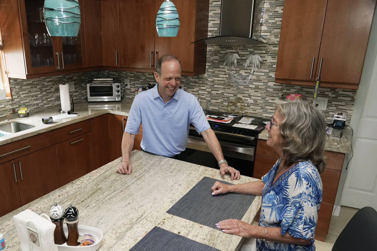 Mark Bendell and his wife Laurie talk in their kitchen, Monday, May 23, 2022, in Boca Raton, Fla. A...