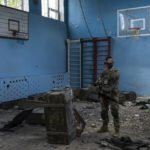 
              A Ukrainian serviceman inspects a school damaged during a battle between Russian and Ukrainian forces in the village of Vilkhivka, on the outskirts of Kharkiv, in eastern Ukraine, Friday, May 20, 2022. (AP Photo/Bernat Armangue)
            