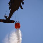 
              In this photo provided by the New Mexico National Guard, New Mexico National Guard Aviation soldiers execute water drops as part of firefighting efforts, dropping thousands of gallons of water from a UH-60 Black Hawks with Bambi buckets on the Calf Canyon/Hermits Peak fire in northern New Mexico Sunday, May, 1, 2022. Thousands of firefighters are battling destructive wildfires in the Southwest as more residents are preparing to evacuate.  (New Mexico National Guard via AP)
            