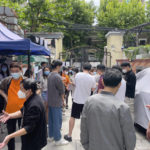 
              Residents gather near the entrance of their compound to demand clarity on when their residential compound would open up in Jingan district in Shanghai on May 25, 2022. Residents in China's largest city of Shanghai have become bolder in demanding the lifting or easing of coronavirus restrictions that have left millions locked up in their compounds for almost two months. (AP Photo)
            