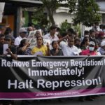 
              National People's Power supporters shout slogans during a protest in Colombo, Sri Lanka, Saturday, May 7, 2022. Diplomats and rights groups expressed concern Saturday after Sri Lankan President Gotabaya Rajapaksa declared a state of emergency and police used force against peaceful protesters amid the country's worst economic crisis in recent memory. Placard reads" Strengthen people's power against government repression." (AP Photo/Eranga Jayawardena)
            