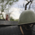 
              An icon stands next to a military helmet at a check point in Mariupol, in territory under the government of the Donetsk People's Republic, eastern Ukraine, Wednesday, May 4, 2022. (AP Photo/Alexei Alexandrov)
            