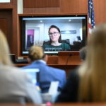 
              Jennifer Howell is seen on a screen testifying in a previously recorded video at the Fairfax County Circuit Courthouse in Fairfax, Va., Tuesday, May 24, 2022. Depp sued his ex-wife Amber Heard for libel in Fairfax County Circuit Court after she wrote an op-ed piece in The Washington Post in 2018 referring to herself as a "public figure representing domestic abuse." (Jim Watson/Pool photo via AP)
            
