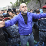 
              Police clash with demonstrators during a protest rally, in Yerevan, Armenia, Monday, May 2, 2022. Police in Armenia's capital on Monday detained 125 anti-government demonstrators that were blocking streets to protest against Prime Minister Nikol Pashinyan. (Vahram Baghdasaryan/Photolure via AP)
            