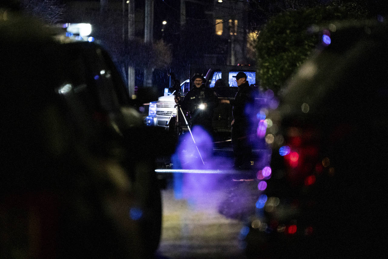 FILE - Police respond to a fatal shooting in Portland on Feb. 19, 2022. As homicides in Oregon's la...