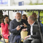 
              Frans Timmermans, center, Executive Vice-President for the European Green Deal take an electric car for transport at the World Economic Forum in Davos, Switzerland, Tuesday, May 24, 2022. The annual meeting of the World Economic Forum is taking place in Davos from May 22 until May 26, 2022. (AP Photo/Markus Schreiber)
            