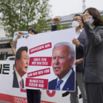 
              FILE - Members of the Progressive Party shout slogans during a rally demanding the withdrawal the government's anti-North Korea policies near the presidential office in Seoul, South Korea, on May 19, 2022. The letters read "Withdrawal the hostile policies towards North Korea." When the U.S. and South Korean leaders meet Saturday, May 21, North Korea’s nuclear weapons and missile program, already a major focus, may receive extra attention if intelligence predictions of an imminent major weapons demonstration by the North, which is struggling with a COVID-19 outbreak, are right.  (AP Photo/Lee Jin-man, File)
            