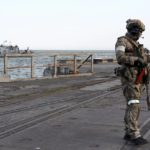 
              A Russian serviceman stands guarding an area of the Mariupol Sea Port in Mariupol, in territory under the government of the Donetsk People's Republic, eastern Ukraine, Friday, May 27, 2022. (AP Photo)
            