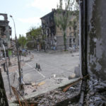 
              People walk among buildings destroyed during fighting in Mariupol, in territory under the government of the Donetsk People's Republic, eastern Ukraine, Wednesday, May 25, 2022. (AP Photo)
            